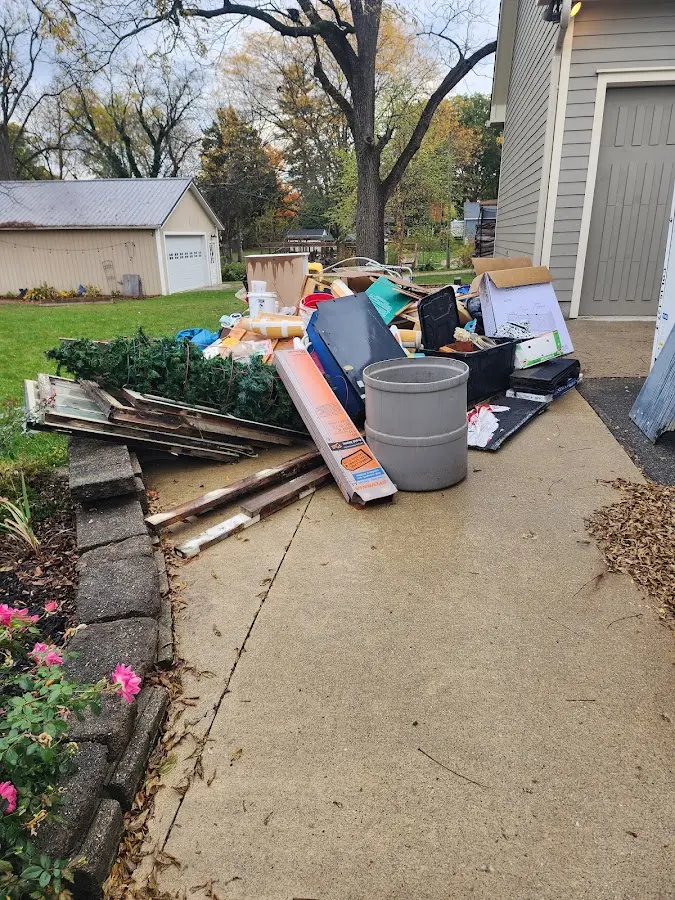 Dumpster being loaded with debris for 12 Yard Dumpster Rental in Batavia